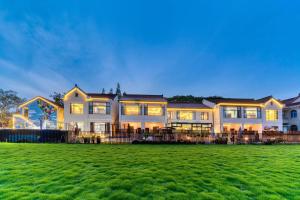 a large house with a lawn in front of it at Hanju Guesthouse - Near Disney Park in Shanghai