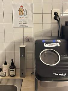 a kitchen with a washing machine next to a sink at GreeneStay Sindang DDP Seoul in Seoul +192 photos