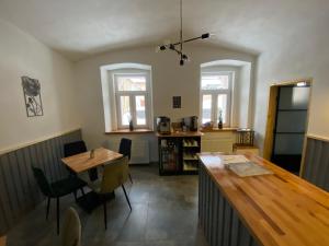 a kitchen with a table and a dining room at Apartmány Mikulov 45 in Mikulov v Krušných Horách