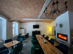 a dining room with a table and chairs and a fireplace at Apartmány Mikulov 45 in Mikulov v Krušných Horách