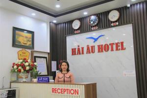 a woman standing at a podium in a hotel at Seagull Hotel in Cat Ba