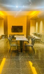 a conference room with chairs and a table and a television at Monaara Leisure - Ella in Ella
