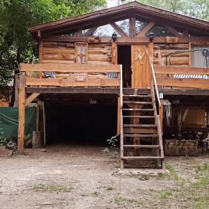 a wooden cabin with a ladder in front of it at Cabaña Lo de VIVI in Casa Grande