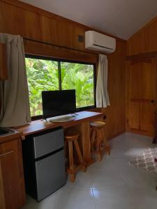 a kitchen with a desk with a computer and a window at Monkey House, Monterrey in San Cristóbal