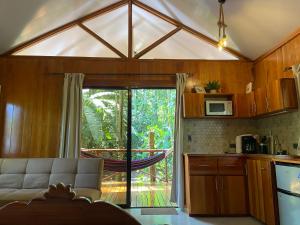 a living room with a couch and a sliding glass door at Monkey House, Monterrey in San Cristóbal
