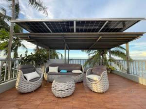 a patio with chairs and a couch on a balcony at Tyne Haven in San Juan