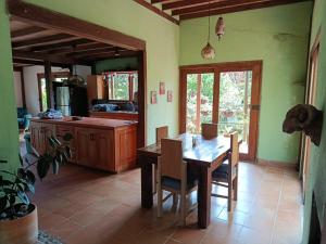 a kitchen with a table and chairs in a room at Moss in Colombia