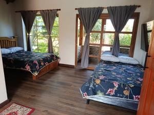 a bedroom with two beds and a window at Moss in Colombia