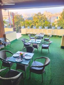 a group of tables and chairs on a patio at Hotel Rivlet By Carlton Suites in Gurgaon