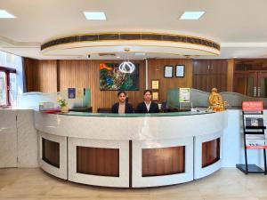 two women sitting at a counter in a lobby at Hotel Rivlet By Carlton Suites in Gurgaon