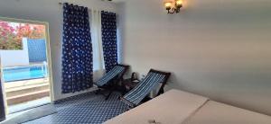 a room with two chairs and a table and a window at Mudra beach villa Gokarna in Gokarna