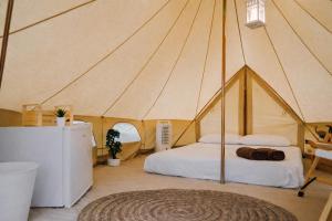 a bedroom with a bed in a tent at Secret View Glamp - La Mariposa in Alghero +5 photos