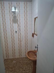 a bathroom with a toilet and a sink at Aconchego II in Juiz de Fora