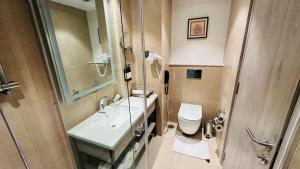 a bathroom with a sink and a toilet and a shower at Regenta Central Jaipur in Jaipur