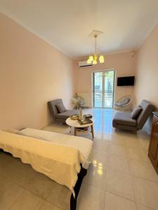 a living room with two beds a couch and a table at Zeus Beach Condo in Vernardhaíika