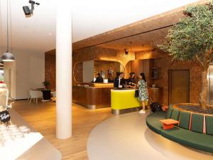 a group of people standing at a counter in a restaurant at Novotel Zurich City West in Zurich +142 photos