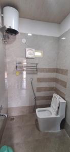 a bathroom with a white toilet in a room at Mudra beach villa Gokarna in Gokarna