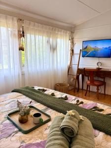 a bedroom with a bed and a table and a piano at Mystic Garden Private Entry & Bath, Pet Friendly in Wentworthville