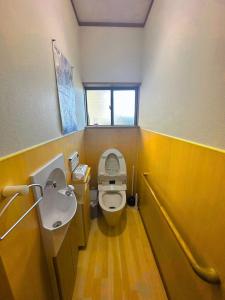a bathroom with a toilet and a sink at MIYABI stay house in Tamana +10 photos