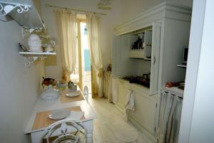 a kitchen with a counter and a table in it at Maison Menton in Menton