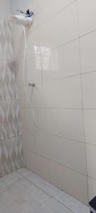 a shower with a hose attached to a wall at Pousada e Pesqueiro Recanto do Peixe in Carmo do Rio Claro +19 photos