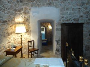 A bed or beds in a room at Tenuta Pigliano Hotel