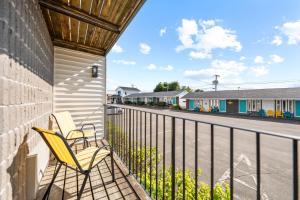 two chairs sitting on a balcony with a street at Shores Inn & Hotel in Shediac