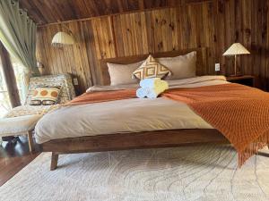 a large bed with two teddy bears sitting on it at City Dodge Home in Xuan An
