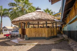 a gazebo with a straw roof on a building at Jamindas Paradise Motel in Kakamega