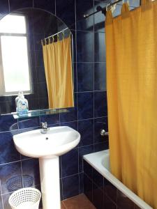 a bathroom with a sink and a mirror and a shower at Pensión Agarimo in Trapagaran