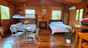 a bedroom with a bed and a table and chairs at Tree House River in Palma