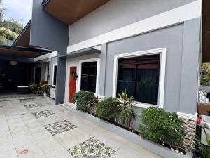 a house with plants on the side of it at Secluded, Modern, Minimalist house - Gray House in Dampalan