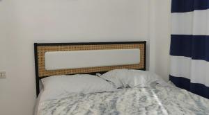 a headboard of a bed in a bedroom at Secluded, Modern, Minimalist house - Gray House in Dampalan