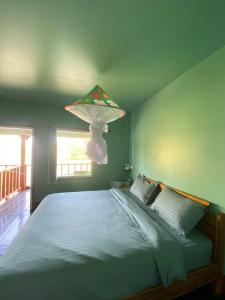 a bedroom with a bed with a lamp above it at Don Det SODA RiverSide Guesthouse in Ban Donsôm Tai +26 photos