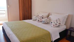 a bed with pillows on it in a bedroom at Villa Marina in Omiš