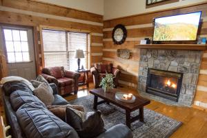 a living room with a couch and a fireplace at Sweet Serenity in Gatlinburg