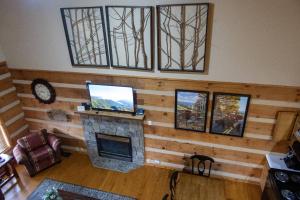 a living room with a fireplace and a tv at Sweet Serenity in Gatlinburg