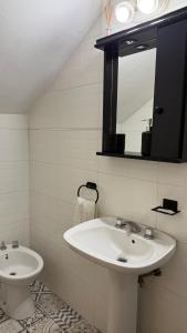 a bathroom with a sink and a mirror at EzeApart in Ezeiza +3 photos