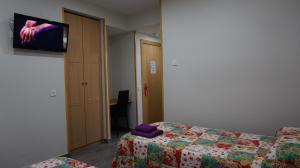 Postel nebo postele na pokoji v ubytování Pensión Calfred II