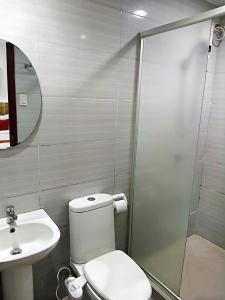 ein Badezimmer mit Toilette, Waschbecken und Dusche in der Unterkunft DBuilders Rooms Hotel in Sampong