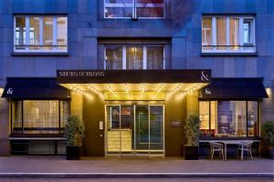 a building with a restaurant with a table in front of it at Neues Schloss Privat Hotel Zurich, Autograph Collection in Zurich +59 photos