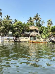 a house on the banks of a river at sacred river homestay in Alleppey