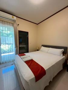 a bedroom with a large white bed with a window at Project 17 B&B in Hua Hin +34 photos