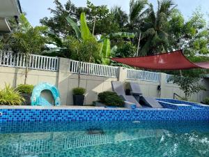 a swimming pool with a slide and a swimming pool at Casa Sandrine Resort in Malolos +5 photos