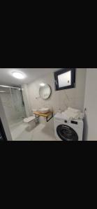 a small bathroom with a stove and a sink at Garsoniera Veronica in Mangalia