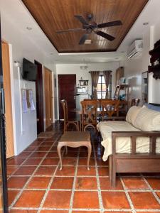 a living room with a bed and a dining room at Serenita Tagaytay in Kibagan