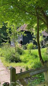 an old house with a bench in front of it at 3 bedroom remote rural idyll on the North Downs in Faversham