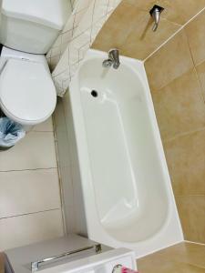 a bathroom with a white toilet and a sink at The Skyline Luxury Unit in Bélanger