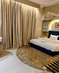 a bedroom with two beds and a rug at Vijay Mansion Pratap Enclave in Jaipur