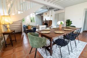 a dining room with a wooden table and chairs at Villa Alexandre III in Dijon
